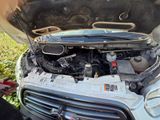 a car that has a broken hood and a broken engine
