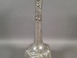 a silver vase that is sitting on a table