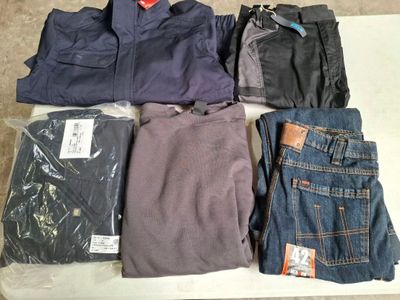several pairs of men ' s clothing are laid out on a table