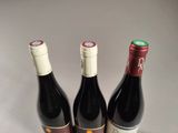 three bottles of wine sitting next to each other on a table