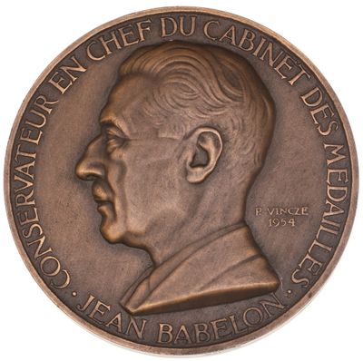 an image of a bronze medal with a portrait of a man on it