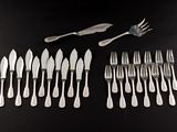 a lot of forks and spoons on the table