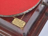 an old record player sitting on top of a wooden table