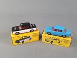 two small toy cars are sitting on top of a box