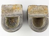 a pair of cement shoes that are sitting on a white surface