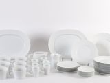 a lot of white plates and cups on the table