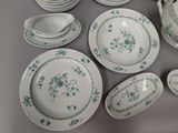 a lot of plates and bowls on the table