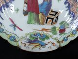 a plate with a picture of a woman and a bird on it