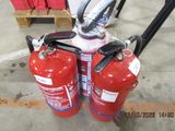 two fire extinguisors sitting on a cart in a warehouse
