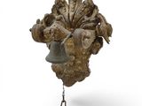 a bell hanging from the side of a tree