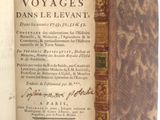 an old book with writing on it sitting on a table