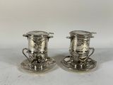 pair of silverplated tea cups and saucers