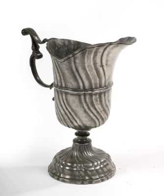 an old silver vase with a handle on a stand