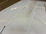 an image of a white surfboard in a garage