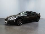 the black sports car is parked in a large room
