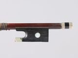 a violin bow with a piece of wood sticking out of it