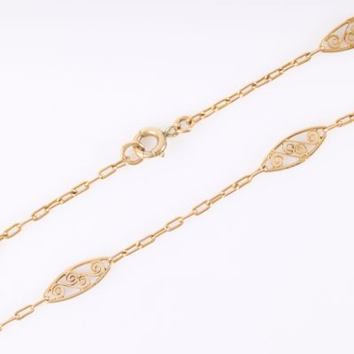 a pair of gold chain bracelets on a white background