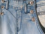 a picture of a pair of jeans hanging on a hanger