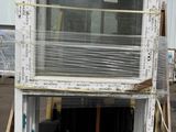 a window that is sitting on a pallet in front of a building