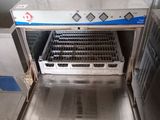 a stainless steel dishwasher that is open in a kitchen