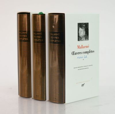 three books sitting next to each other on a white surface