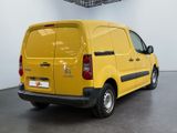 the yellow van is parked in the large room of the building