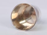 a silver ring that is sitting on a white surface