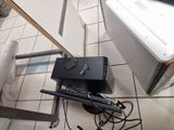 a picture of a laptop and a television on a tiled floor
