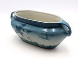 a blue and white bowl with a bird design on it