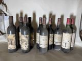 several bottles of wine are lined up in a row on a table