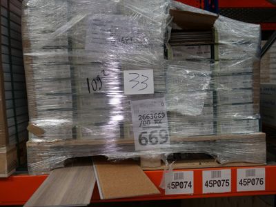 a large stack of boxes on a pallet in a warehouse