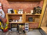 a room with a lot of shelves and pictures on the wall