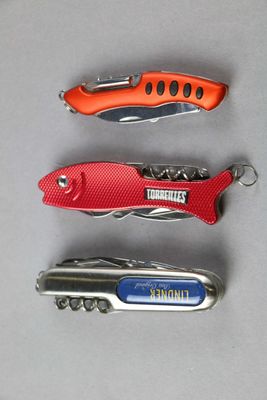 four different types of knives are lined up on a table