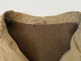 a close up of a tan jacket with a brown lining