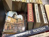 many books stacked on top of each other on a table
