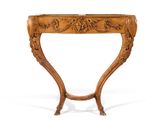 an ornately carved console table with a wooden top