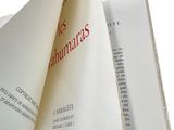a folded book with a red text on it