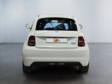 a white car that is parked in a room