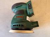 a close up of a bosch orbital sander on a white surface