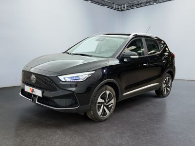 the black suv is parked in a large room with a white wall