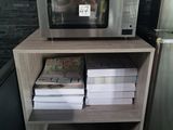 a microwave that is sitting on a shelf in a kitchen
