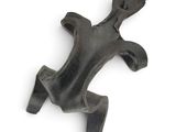 a metal object that looks like a frog on a white surface