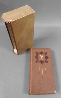 a brown book and a brown case on a gray surface