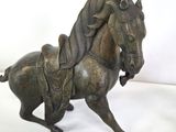 a bronze statue of a horse on a white background