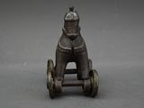 antique cast iron toy horse on wheels on a gray background