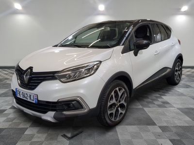 a white car parked on a checkered floor in a garage