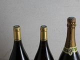 three bottles of wine sitting on a table next to each other