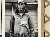 a black and white photo of a man in a pilot ' s uniform
