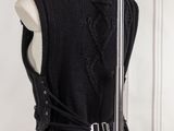 the back of a woman ' s black dress with a hood on it