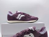 purple saucy sneakers with white soles on a white box